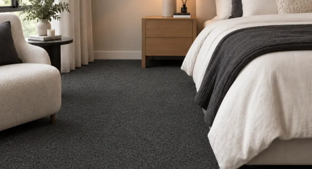 Dark grey Hip Hop carpet in a modern bedroom with neutral furnishings, available from Go Carpets Gold Coast and Tweed Heads.